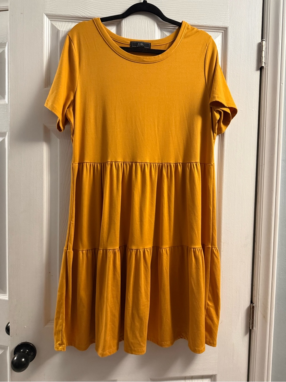 Vibe brand short-sleeve tiered babydoll mini dress in a mustard yellow 1X